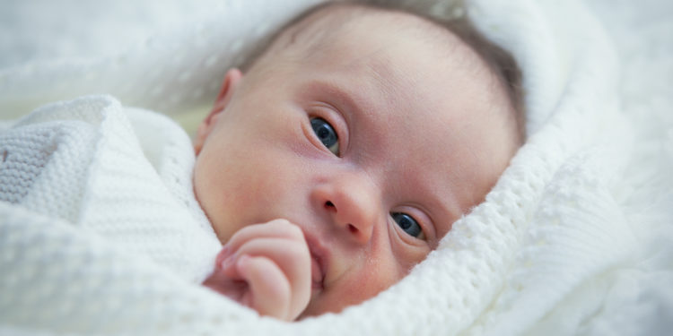 newborn with Down syndrome is quiet and looks